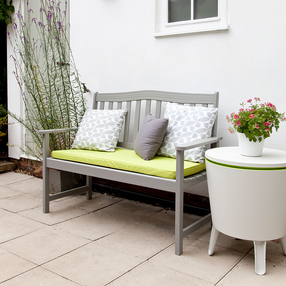 Grey bench with grey seat cushion on patio