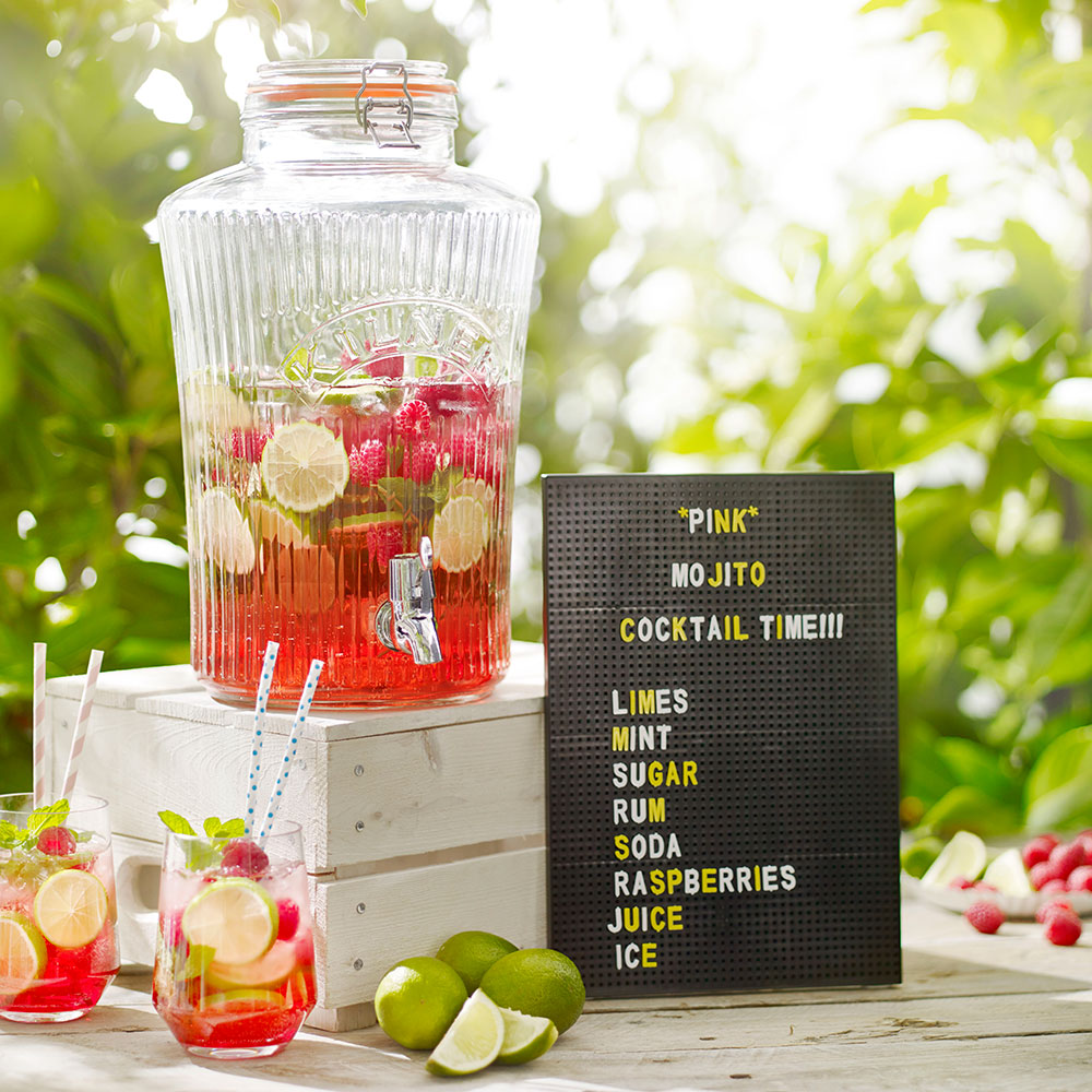 Glass Kilner drinks dispenser beside cocktail menu