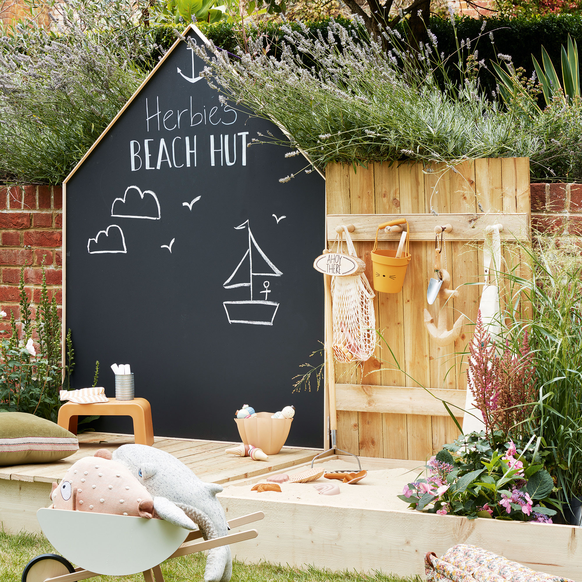 Garden with built in kids area with blackboard and sandpit